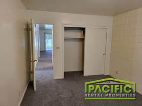 Medford apartment for rent - a bedroom with an open closet and a carpeted floor