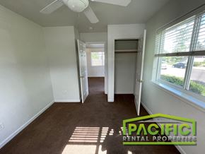 Medford apartment for rent - an empty room with a hallway to a closet and a ceiling fan