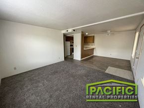 Medford apartment for rent - an empty living room with carpet and a kitchen