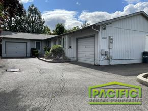 Medford apartment for rent - a parking lot in front of a white building