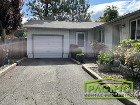Medford apartment for rent - a driveway in front of a house with a white garage door