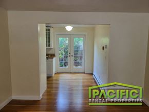 Ashland apartment for rent - an empty living room with a hard wood floor and a door into a kitchen