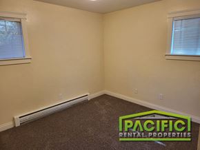 Ashland apartment for rent - an empty room with a pacific rental properties logo on the floor