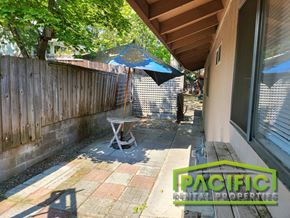 Ashland apartment for rent - a backyard patio with a table and an umbrella