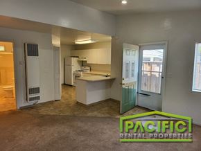 Ashland apartment for rent - an empty kitchen with an open door into the living room