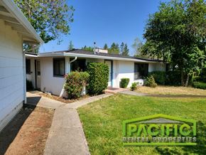 Ashland apartment for rent - a small white house with a yard and a sidewalk