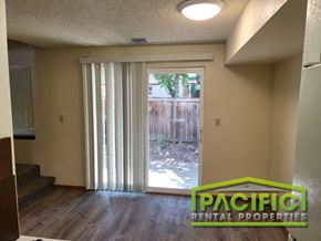Ashland apartment for rent - a living room with a sliding glass door to a backyard