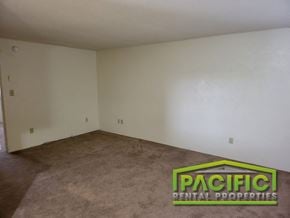 Ashland apartment for rent - the living room of an empty house with carpet and white walls