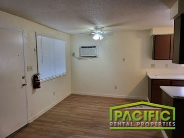 Ashland apartment for rent - an empty kitchen with a ceiling fan and a window