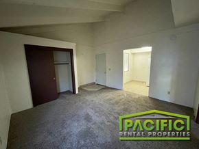 Ashland apartment for rent - an empty living room in a residential home with carpet and a door to a closet