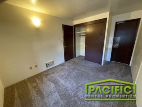 Ashland apartment for rent - an empty living room with a carpeted floor and two doors