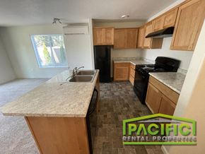 Medford apartment for rent - an empty kitchen with wood cabinets and a sink