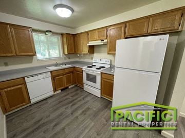 Medford apartment for rent - a kitchen with white appliances and wooden cabinets