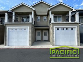 Medford apartment for rent - an apartment building with white garage doors and a pacific rental properties sign