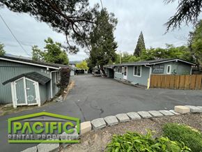 Ashland apartment for rent - a street with blue buildings and a parking lot