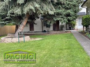 Ashland apartment for rent - a yard with a tree in front of a house