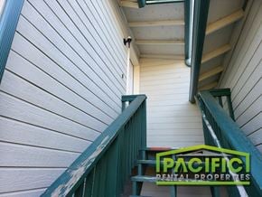 Ashland apartment for rent - a staircase with a green bench next to a white building