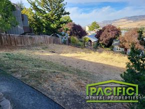 Ashland apartment for rent - a backyard with a dirt road and a fence