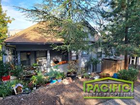 Ashland apartment for rent - a backyard with a house and plants in front of it