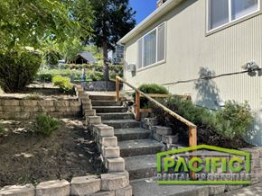 Ashland apartment for rent - a retaining wall with stone steps next to a house