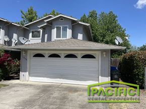 Eagle Point apartment for rent - A house with a garage door and a sign that says "Pacific Rental Properties".