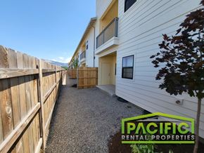 Medford apartment for rent - a walkway in front of a house with a wooden fence