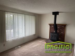 Ashland apartment for rent - A living room with a fireplace and a window with blinds.
