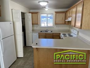 Medford apartment for rent - a kitchen with wooden cabinets and a white counter top