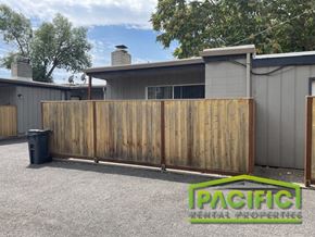 Medford apartment for rent - a wood privacy fence in front of a house