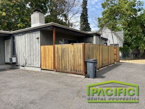 Medford apartment for rent - a wooden privacy fence in front of a house