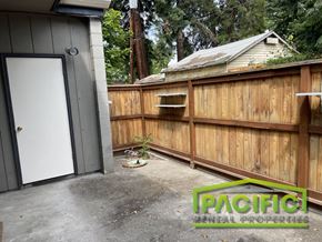 Medford apartment for rent - a backyard with a wooden fence and a garage door