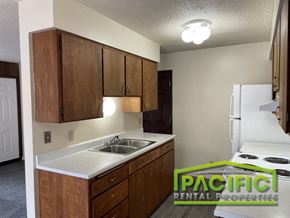 Medford apartment for rent - a kitchen with white appliances and wooden cabinets