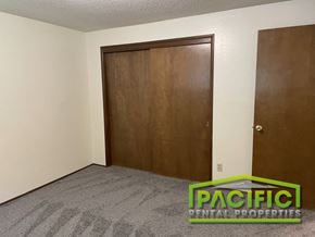Medford apartment for rent - a bedroom with a wooden closet and a carpeted floor