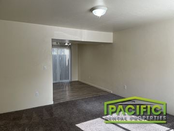 Ashland apartment for rent - the living room of a new home with carpet and a door to the dining room