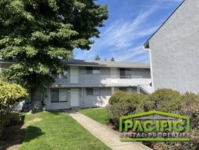 Ashland apartment for rent - a white house with a yard and a tree in front of it