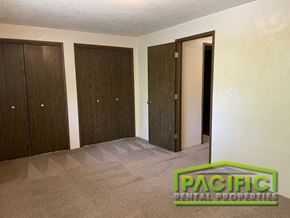 Ashland apartment for rent - a living room with three closets and a carpeted floor