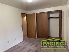 Ashland apartment for rent - a living room with a carpeted floor and two closet doors