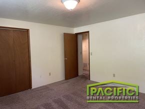 Ashland apartment for rent - a bedroom with a carpeted floor and a door to a closet