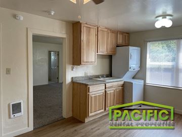 Ashland apartment for rent - a small kitchen with wooden cabinets and a white refrigerator