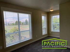Ashland apartment for rent - a living room with large windows overlooking a field