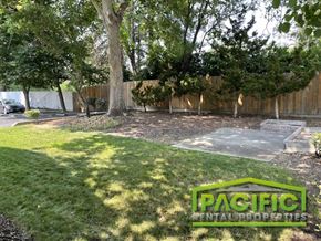 Ashland apartment for rent - a backyard with grass and a tree and a fence
