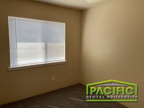 Central Point apartment for rent - the interior of a bedroom with a window and a carpeted floor