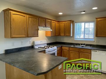 Medford apartment for rent - A kitchen with wooden cabinets and a stove top oven.