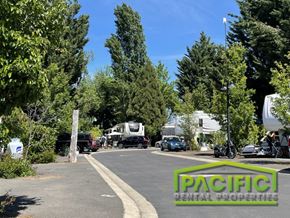 Medford apartment for rent - A parking lot with a sign that says Pacific Rental Properties.
