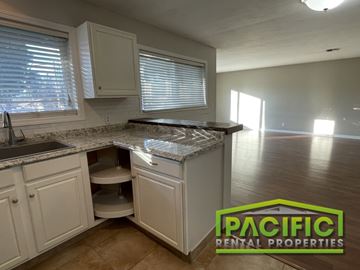 Medford apartment for rent - A kitchen with a countertop and cabinets is shown in a well-lit room.