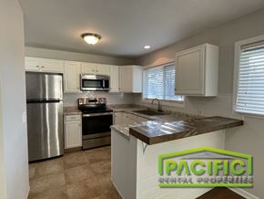 Medford apartment for rent - A kitchen with a refrigerator, microwave, oven, and sink.