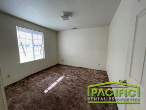 Medford apartment for rent - A room with a carpet floor and a window letting in sunlight.