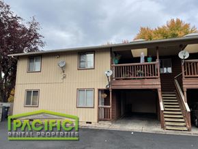Medford apartment for rent - a tan house with a wooden deck and stairs