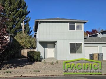 Grants Pass apartment for rent - a white house with a sign in front of it