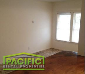 Ashland apartment for rent - an empty living room with a wooden floor and a window